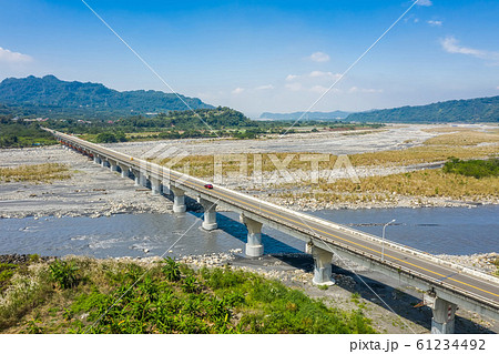 bridge over river with golden miscanthus 61234492