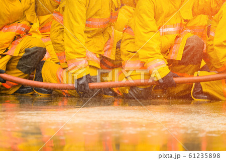 fireman fighting fire flame with water and extinguisher in training workshop fireman fighting fire flame with water and extinguisher in training workshop 61235898