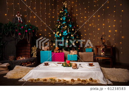 Christmas Room Interior Design, Xmas Tree Decorated By Lights Presents Gifts Toys, Candles And Garland Lighting Indoors 61238583