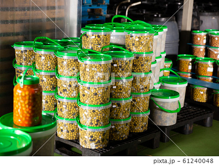 Stacked plastic buckets with pickled olives 61240048