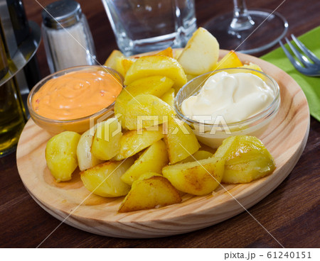 Patatas bravas with garlic mayonnaise and sauce Patatas bravas with garlic mayonnaise and sauce 61240151
