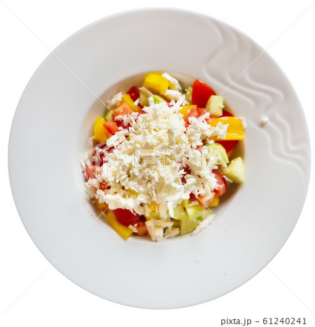 Shopska salad — dish of Balkan cuisine. Cucumbers, tomatoes, bell peppers and brynza (salted sheep cheese) Shopska salad — dish of Balkan cuisine. Cucumbers, tomatoes, bell peppers and brynza (salted sheep cheese) 61240241