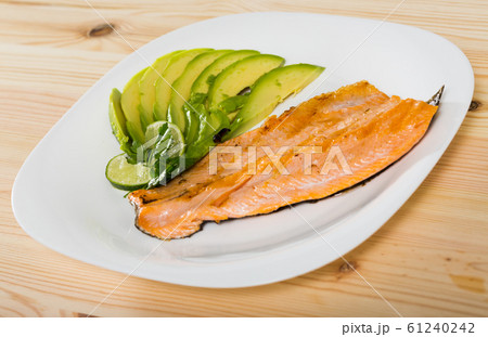 Image of fried trout fillet served with avocado on the plate Image of fried trout fillet served with avocado on the plate 61240242