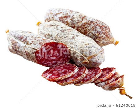 Italian cacciatori salami sausages cut in slices on a wooden desk, closeup 61240619