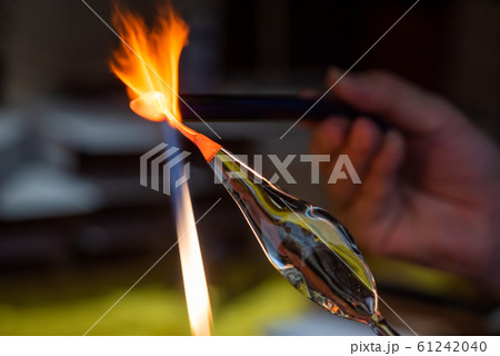 Artist works on glass with fire 61242040