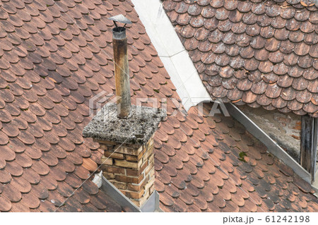 chimney on roof tiles of a house as a background chimney on roof tiles of a house as a background 61242198