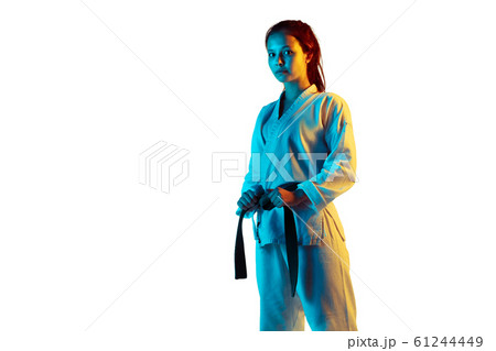 Confident junior in kimono practicing hand-to-hand combat, martial arts Confident junior in kimono practicing hand-to-hand combat, martial arts 61244449