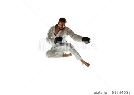 Confident coach in kimono practicing hand-to-hand combat, martial arts 61244655