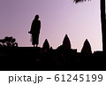 Silhouette of Angkor Wat and girl traveler with photo camera on the sunrise. Angkor Wat - Hindu 61245199
