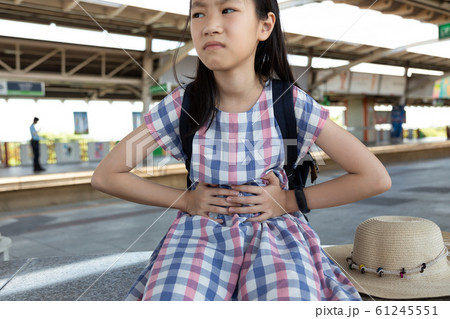 Asian girl suffering from stomachache,health care problem 61245551