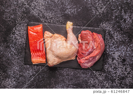 Meat, fish, chicken on the board. Meat, fish, chicken on the board. 61246847
