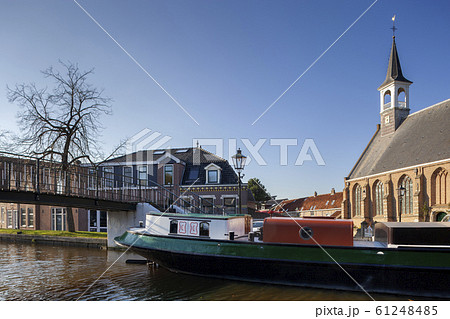 View on a historical barge and footbridge in View on a historical barge and footbridge in 61248485