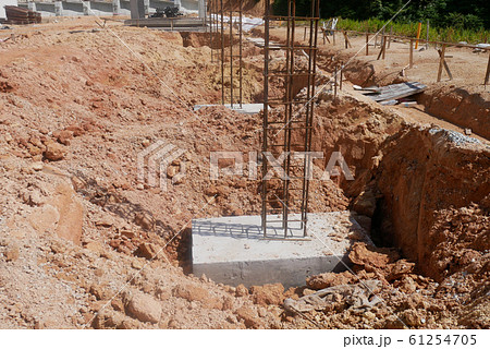 Casted pile cap at the construction site. It is part of the building foundation system. Protruded rebar is for the next stage of work. 61254705