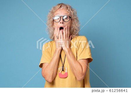 Surprised, shocked woman holding hands near cheeks with wide open eyes and mouth Surprised, shocked woman holding hands near cheeks with wide open eyes and mouth 61256641