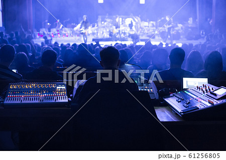 Soundman working on the mixing console. 61256805