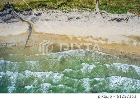 Aerial view of sandy beach and ocean with waves Aerial view of sandy beach and ocean with waves 61257353