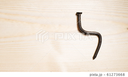 bent nail on a wooden board. Concept stoop, bent nail on a wooden board. Concept stoop, 61273668