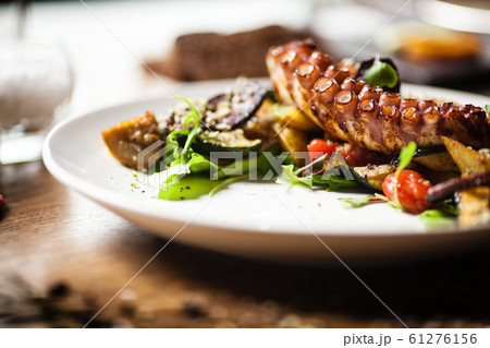 Octopus salad served on a plate in restaurant Octopus salad served on a plate in restaurant 61276156