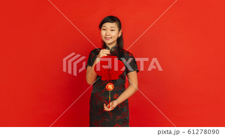Happy Chinese new year. Asian young girls's portrait isolated on red background Happy Chinese new year. Asian young girls's portrait isolated on red background 61278090