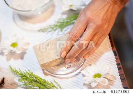 Female hand taking a cosmetic soap from the table Female hand taking a cosmetic soap from the table 61278862