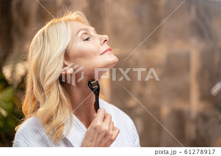 Beautiful mature woman doing a neck massage Beautiful mature woman doing a neck massage 61278917