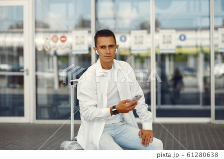Handsome man standing near the airport Handsome man standing near the airport 61280638
