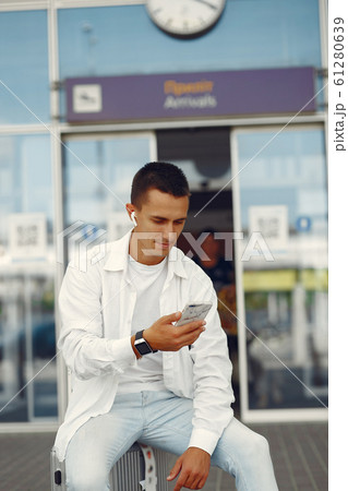 Handsome man standing near the airport Handsome man standing near the airport 61280639