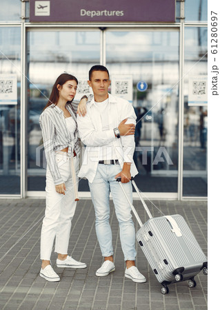 Beautiful couple standing near the airport Beautiful couple standing near the airport 61280697