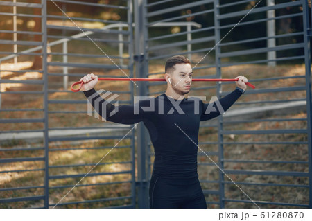 Handsome man training in a summer park Handsome man training in a summer park 61280870