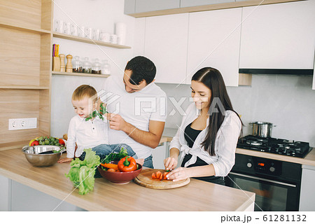 Family prepare the salad in a kitchen Family prepare the salad in a kitchen 61281132