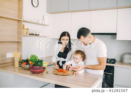 Family prepare the salad in a kitchen Family prepare the salad in a kitchen 61281507