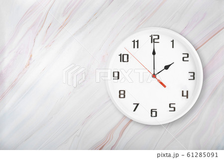 White round wall clock on natural marble background 61285091