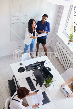 Asian woman discuss with african coach new business plan 61287929