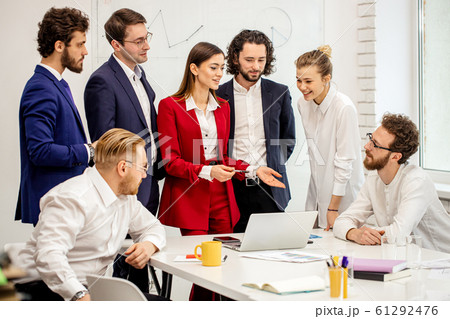 friendly business team together in light boardroom 61292476