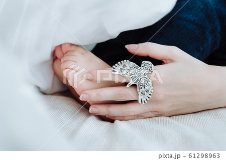 Maternal hand touches baby feet Maternal hand touches baby feet 61298963