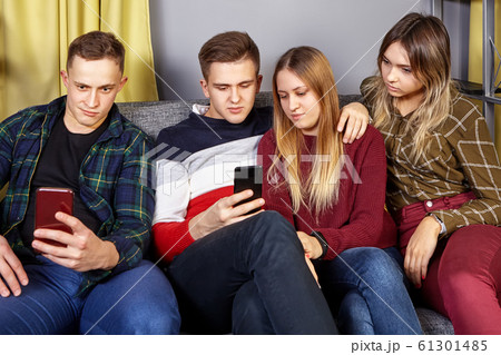 Small group of students in a college dorm. 61301485