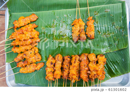 Grilled pork with sweet spicy sauce on banana Grilled pork with sweet spicy sauce on banana 61301602
