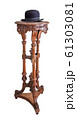 Black bowler hat on an old carved wooden table 61303081