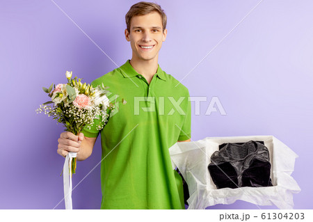 confident smiling delivery man with flowers confident smiling delivery man with flowers 61304203