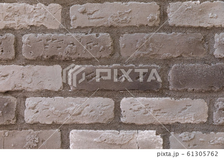 close-up of a light gray antique brick wall sample 61305762
