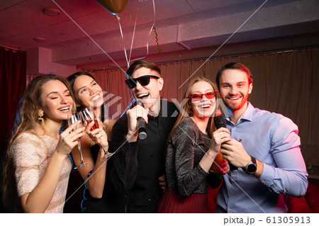 Young caucasian people dance and sing in karaoke club Young caucasian people dance and sing in karaoke club 61305913