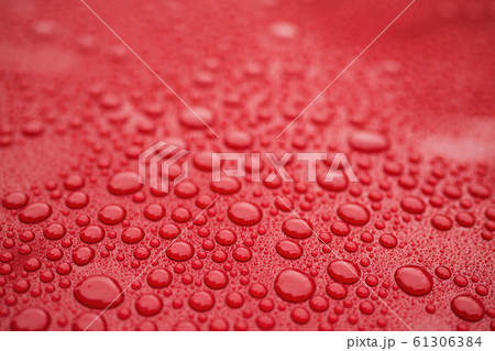 Closeup red car paint surface with hydrophobic ceramic coating 61306384