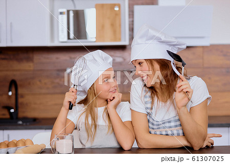 smiling woman and daughter dream about baking 61307025