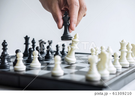 Business woman playing chess and thinking strategy Business woman playing chess and thinking strategy 61309210