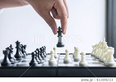 Business woman playing chess and thinking strategy Business woman playing chess and thinking strategy 61309213