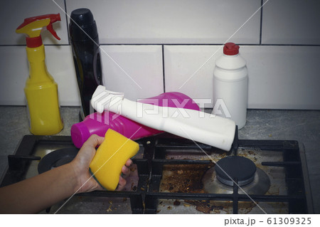 Dirty, top of the gas stove with bits of food. House cleaning. Dirty, top of the gas stove with bits of food. House cleaning. 61309325