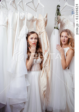 two surprised women in wedding salon two surprised women in wedding salon 61309824