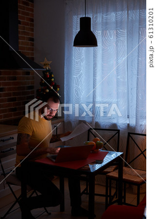 young male with laptop in kitchen young male with laptop in kitchen 61310201