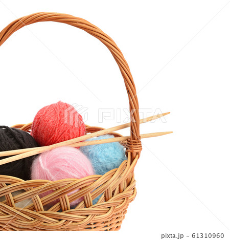Wool balls in a basket isolated on a white 61310960