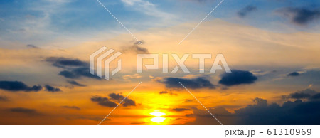Cloudy sky and bright sunrise over the horizon. 61310969